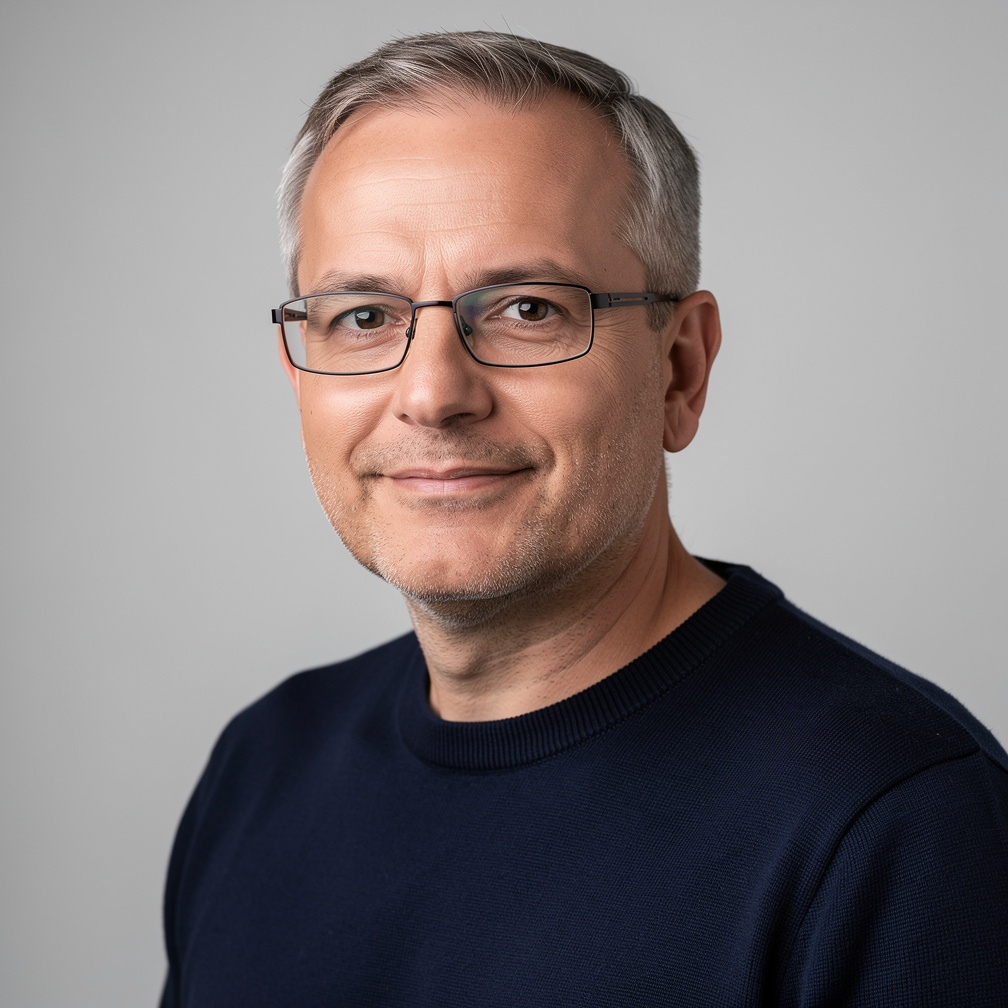 Studio portrait of a European man with glasses and short hair