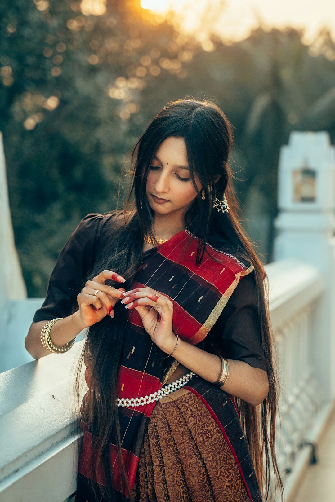 Studio portrait of a South Asian woman with long dark hair