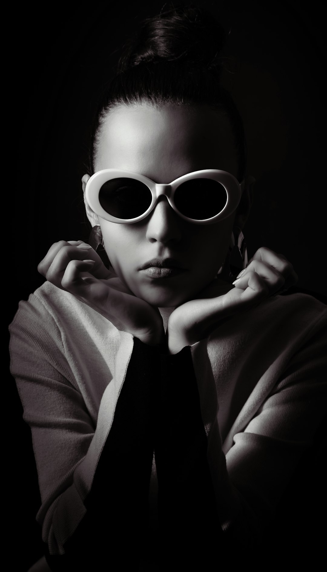 Studio portrait of a European woman with glasses and a bun