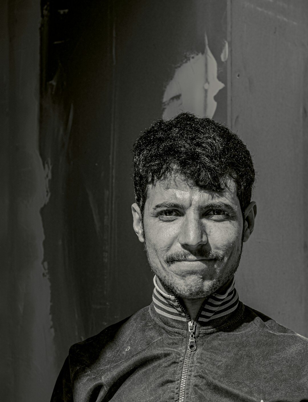 Studio portrait of a Middle Eastern man with short dark hair
